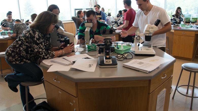 一群人聚集在一张实验桌旁